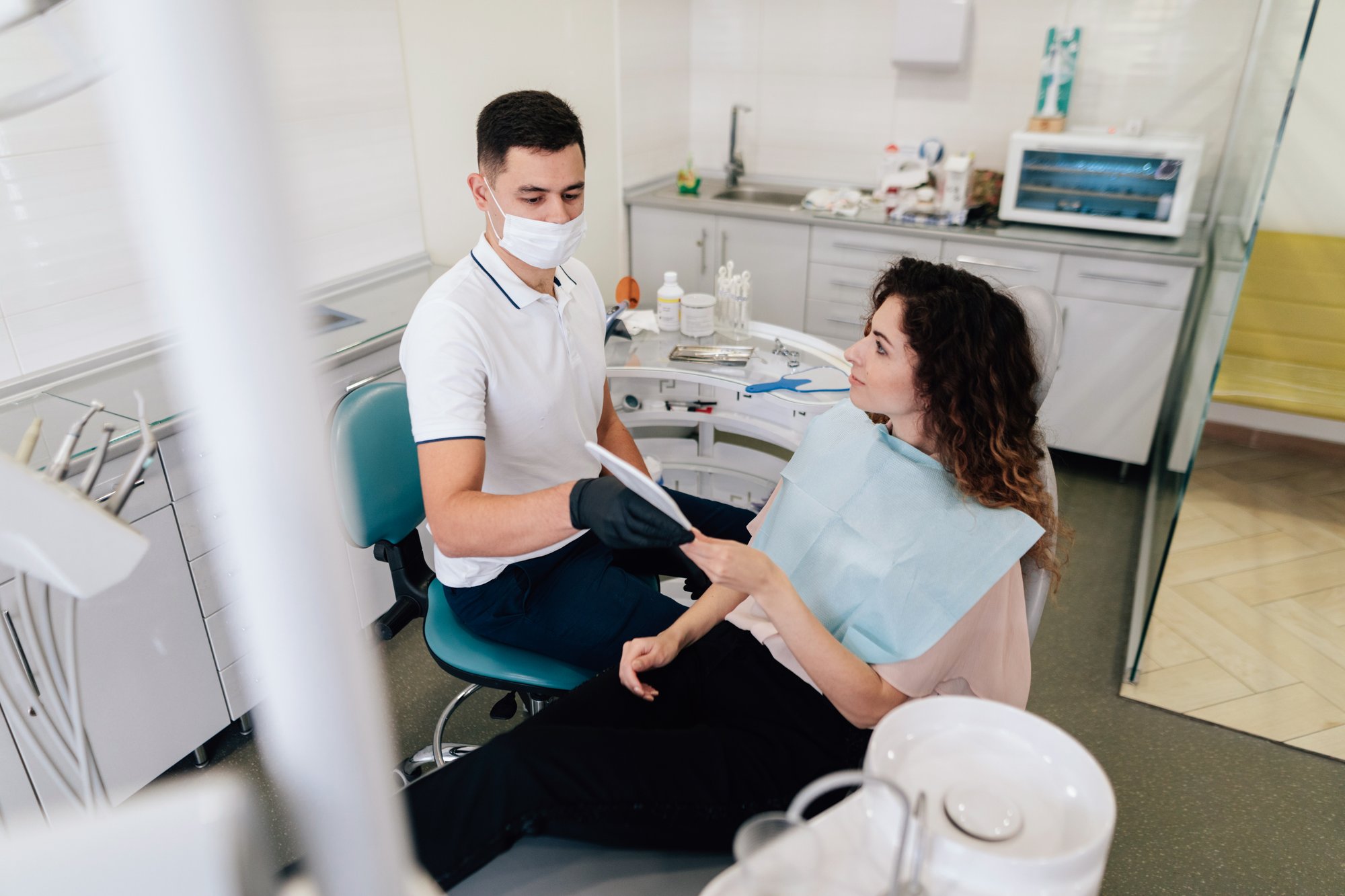 dentist-giving-mirror-patient-office